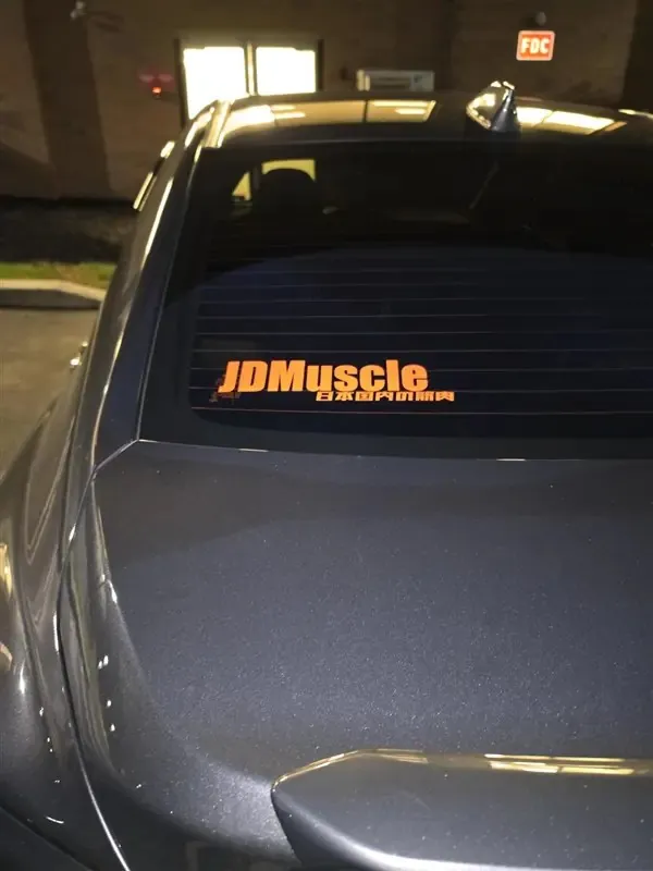 Orange JDMuscle decal on the rear window