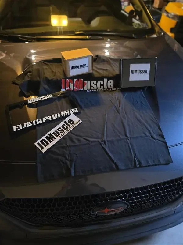 JDMuscle merch laid out on the hood