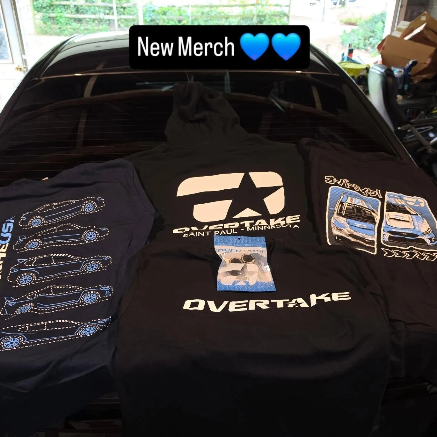 New Overtake merch laid out on the car