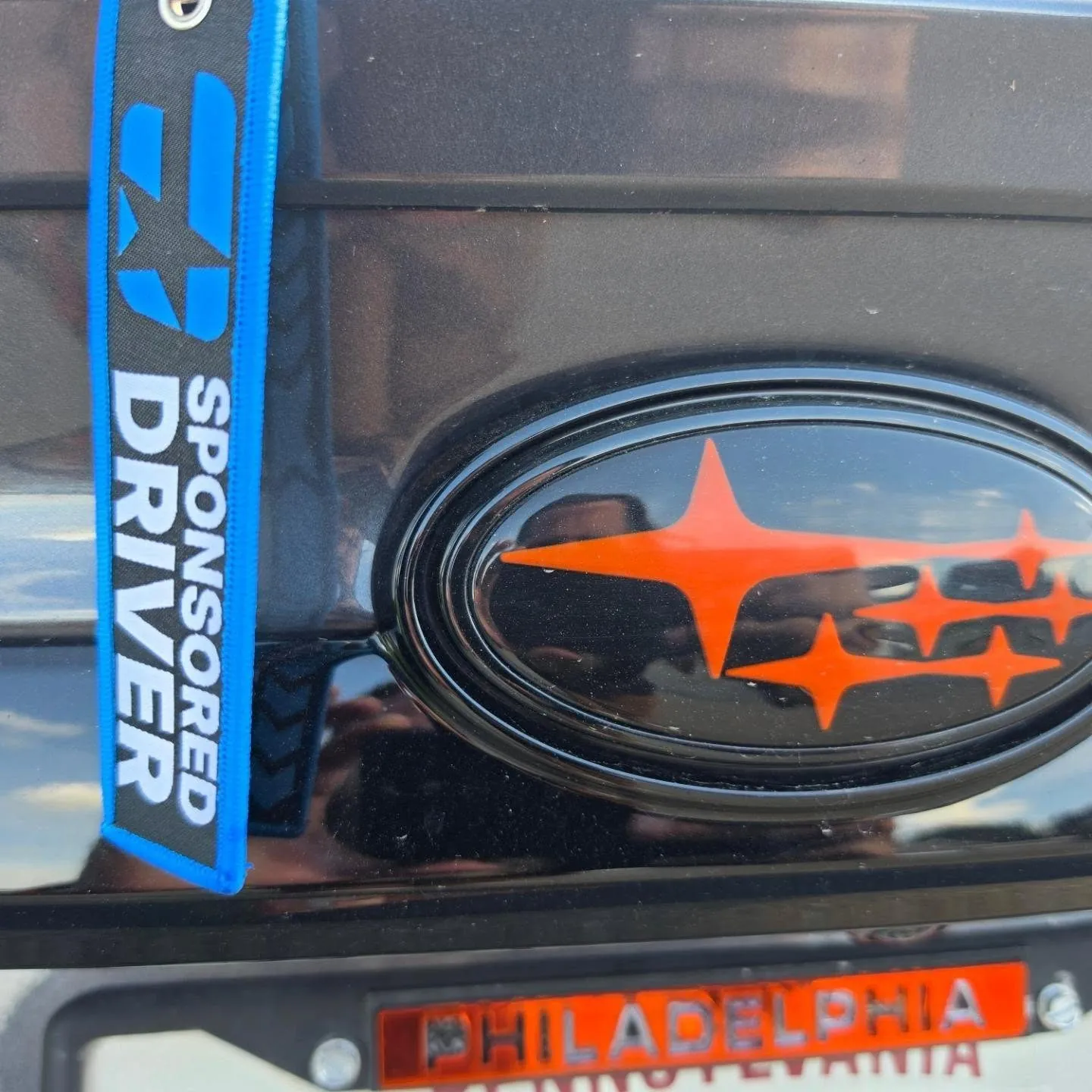 Sponsored driver tag beside the orange badge