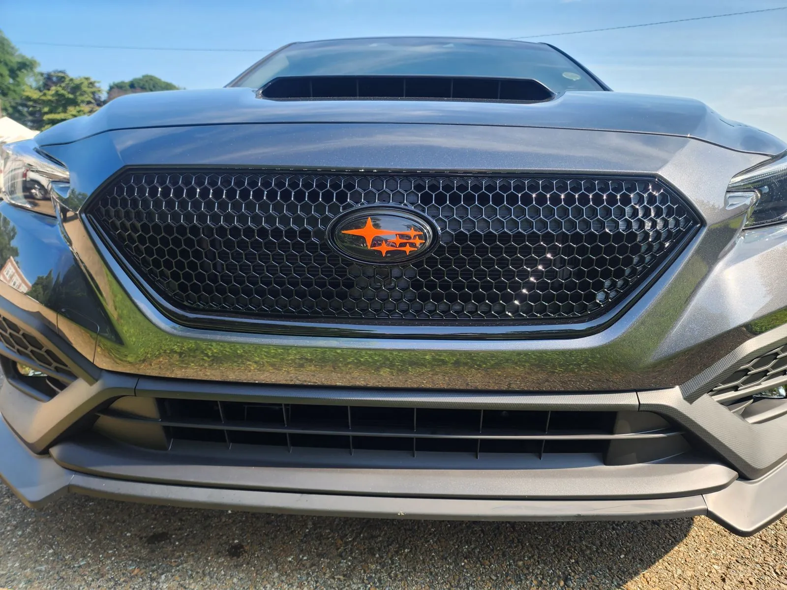 Orange SMY Subaru badge on the grille