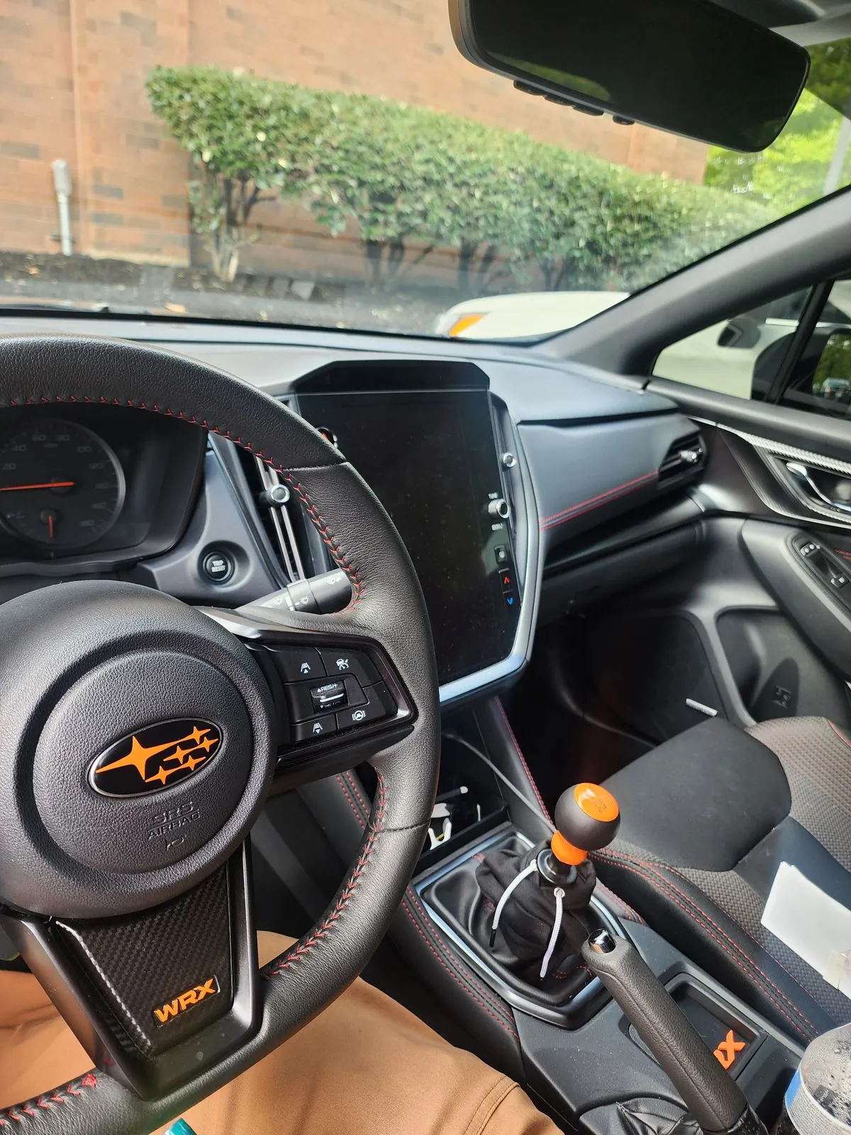 Cockpit with orange wheel badge, WRX lettering and shift knob
