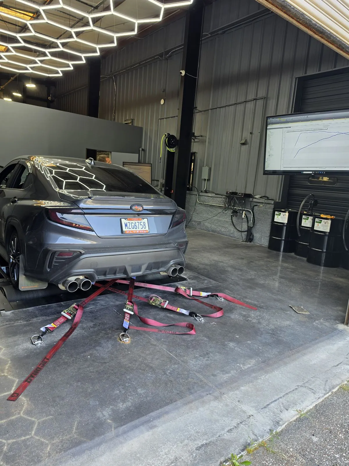 Car strapped down at the shop on tune day