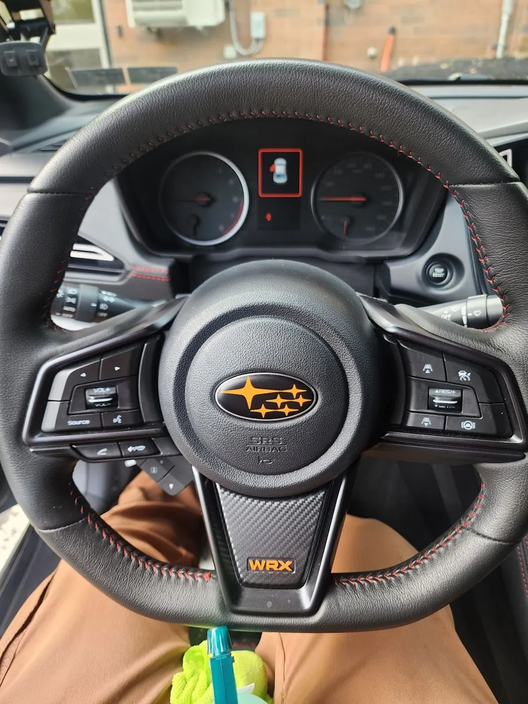 Orange stars and WRX lettering on the wheel