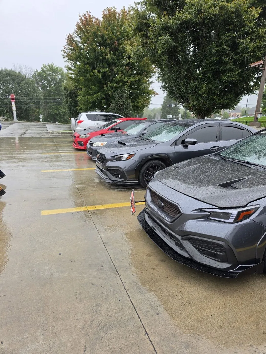 Rainy lot, Fenrir parked by the trees