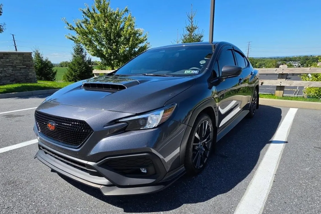 Project Fenrir WRX in full on a sunny day, hills and trees behind