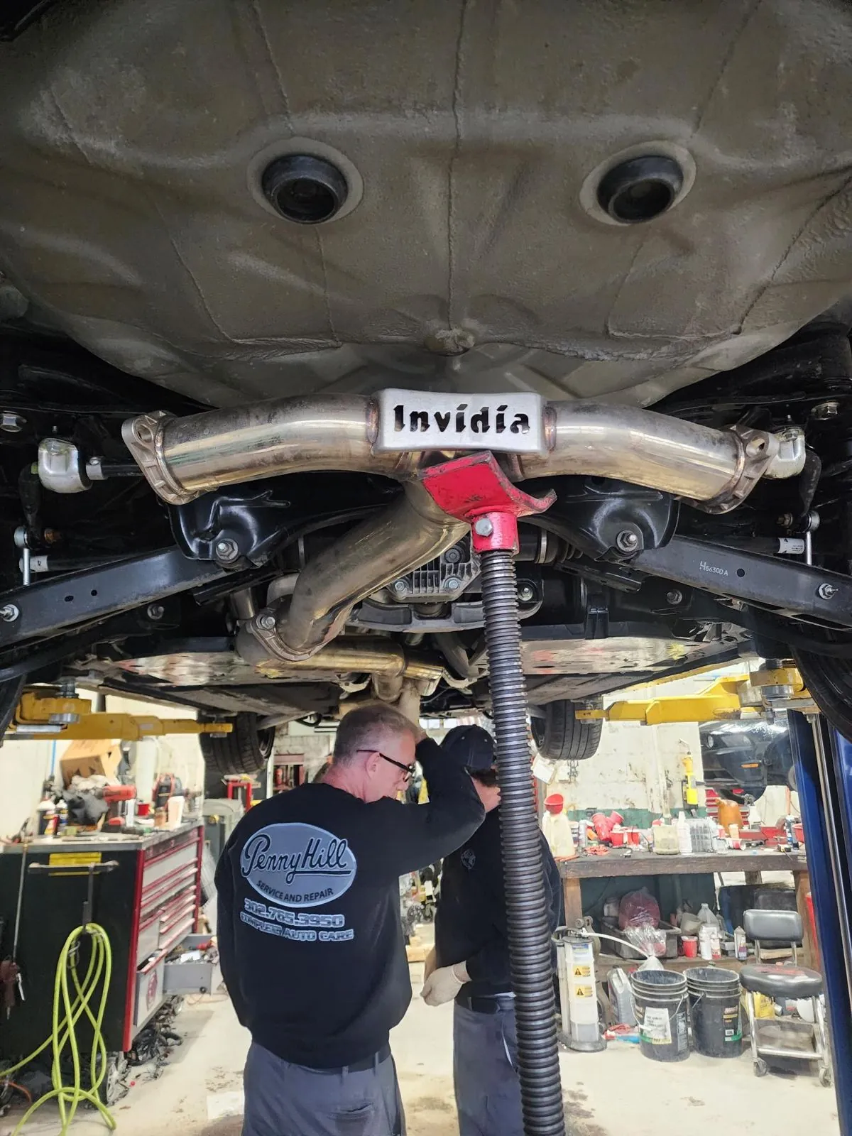 Invidia catback going on, car on the lift