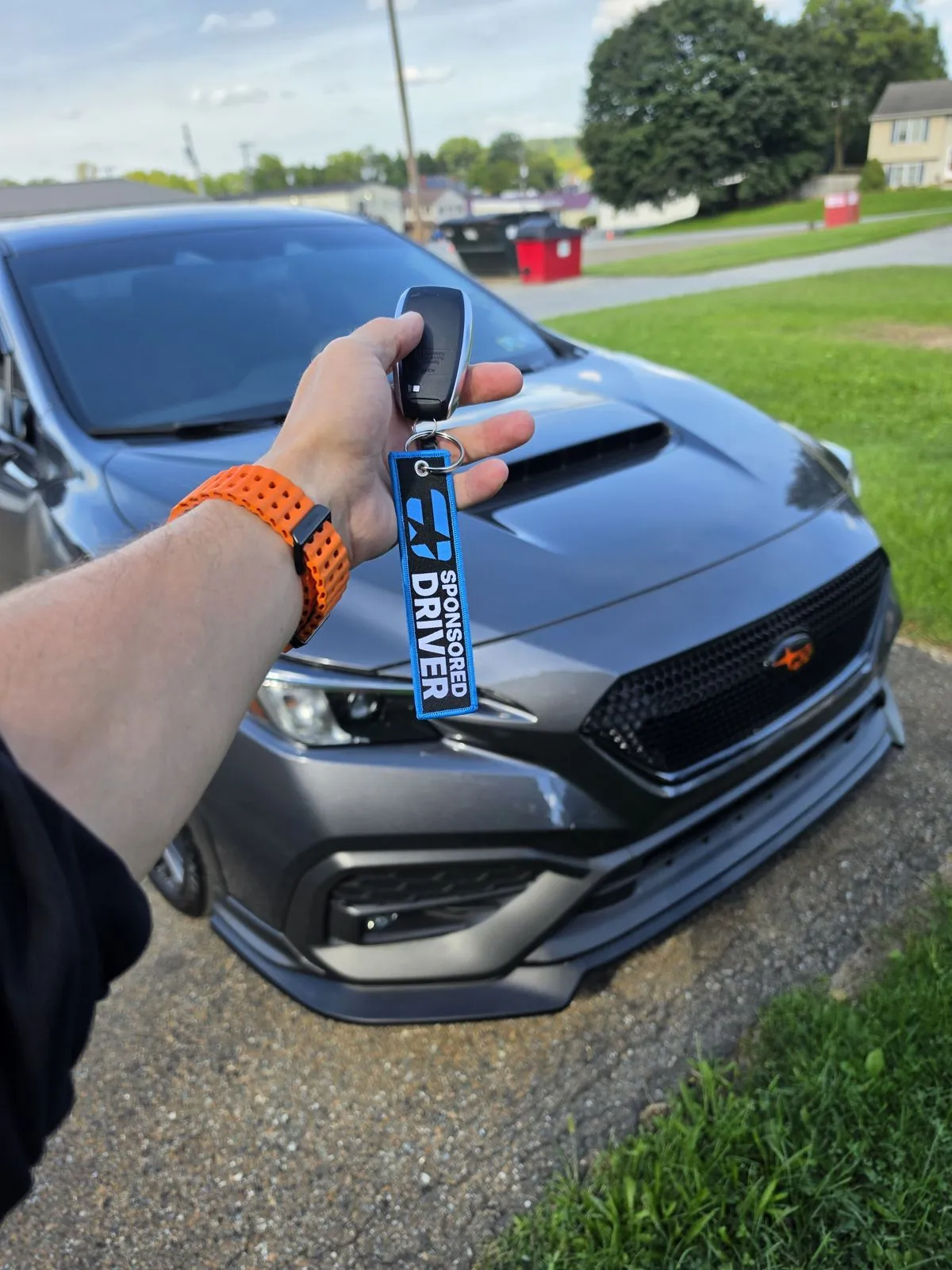 Keys with the sponsored driver tag in front of the car
