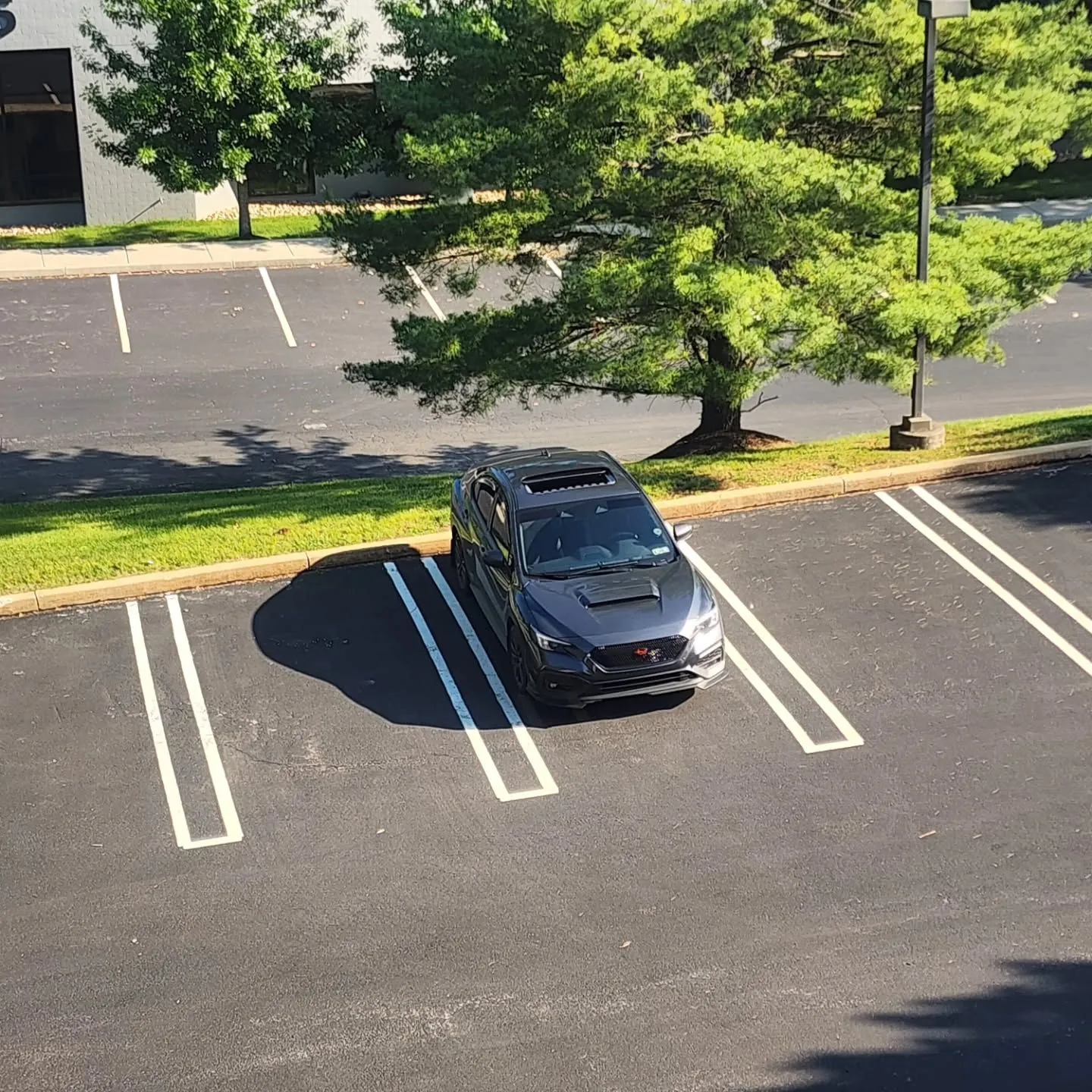 The car alone in an empty lot from above